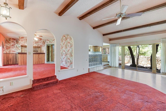 9401 Cedar Crest Dr, Austin, TX 78750 - unfurnished living room featuring ceiling fan, arched walkways, carpet, and a textured ceiling