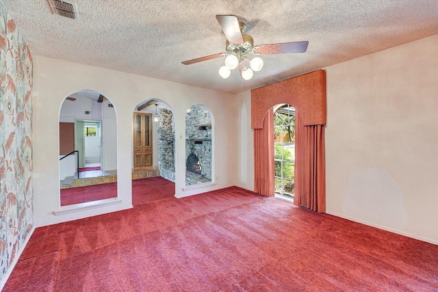 9401 Cedar Crest Dr, Austin, TX 78750 - carpeted spare room featuring ceiling fan, a textured ceiling, and arched walkways