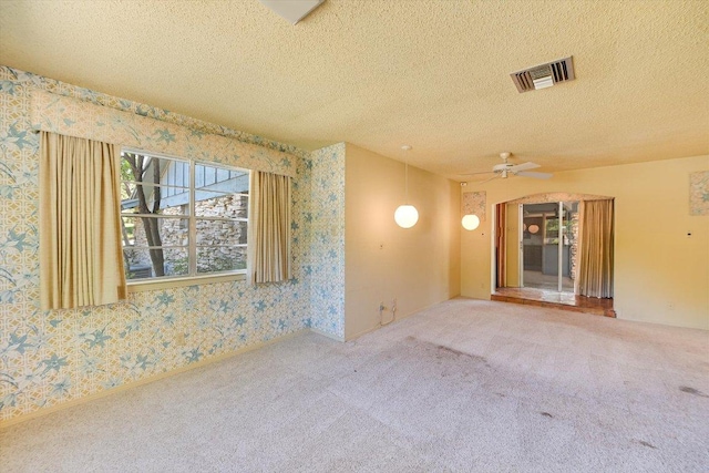 9401 Cedar Crest Dr, Austin, TX 78750 - carpeted empty room featuring wallpapered walls, a textured ceiling, and a ceiling fan