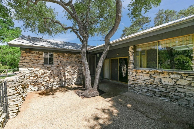 9401 Cedar Crest Dr, Austin, TX 78750 - entrance to property featuring stone siding and a patio area