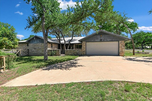 9401 Cedar Crest Dr, Austin, TX 78750 - single story home featuring stone siding, an attached garage, a front lawn, and concrete driveway