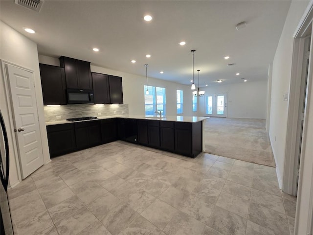 kitchen with black microwave, light carpet, dark cabinetry, visible vents, and recessed lighting