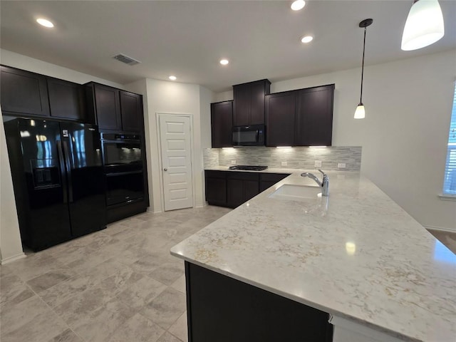 kitchen with a peninsula, a sink, tasteful backsplash, visible vents, and black appliances