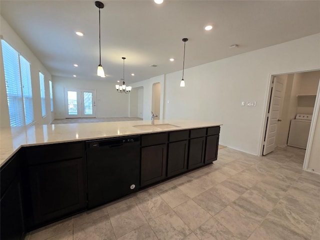 kitchen featuring a sink, dishwasher, arched walkways, washer / clothes dryer, and dark cabinets