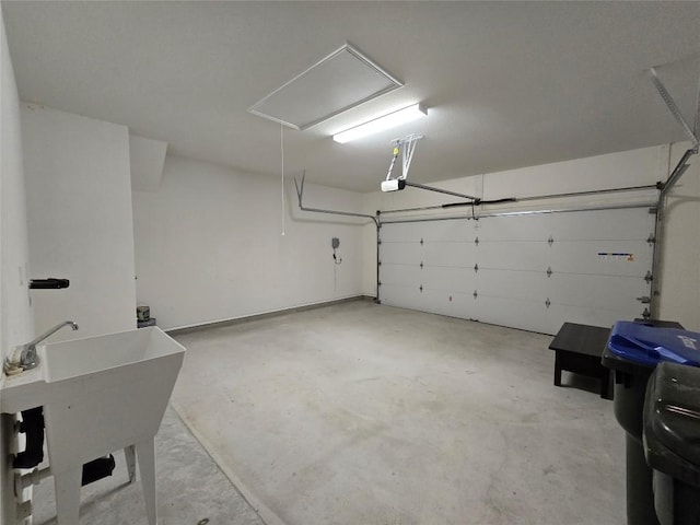 garage with a sink and a garage door opener