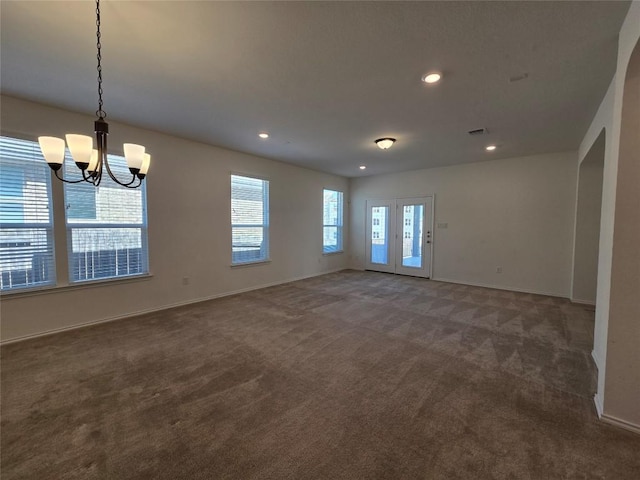 unfurnished dining area with carpet flooring, visible vents, baseboards, an inviting chandelier, and recessed lighting