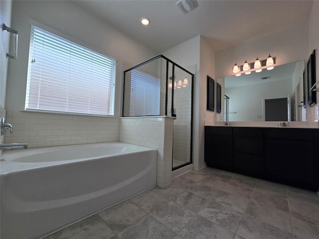 bathroom featuring a sink, double vanity, a stall shower, visible vents, and a garden tub