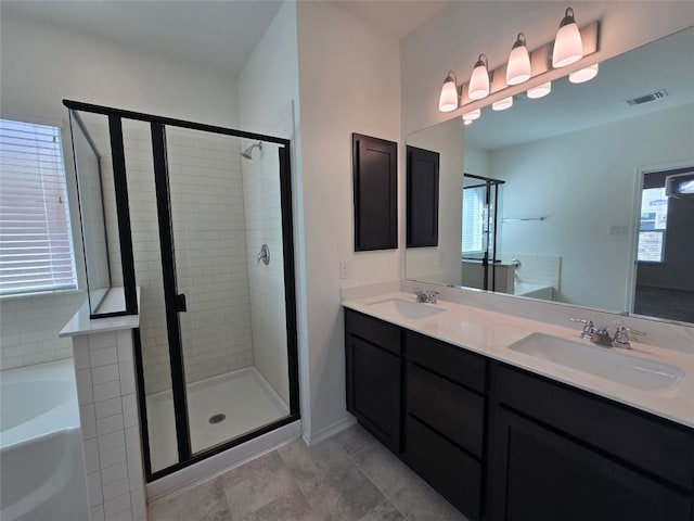 full bath with visible vents, a sink, and a shower stall