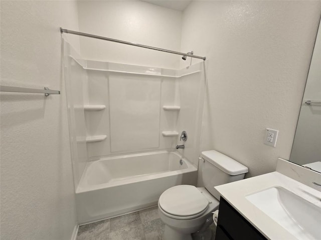 bathroom featuring a textured wall, toilet, and vanity