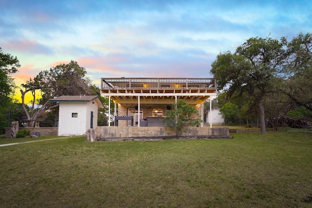 back of property with a yard and a deck