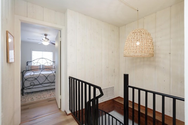 hall featuring visible vents and light wood finished floors
