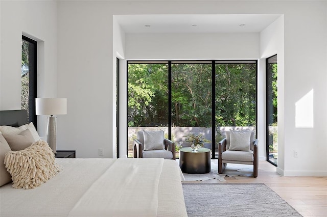 2003 Sharon, Austin, TX 78703 - bedroom featuring wood finished floors, access to exterior, and baseboards