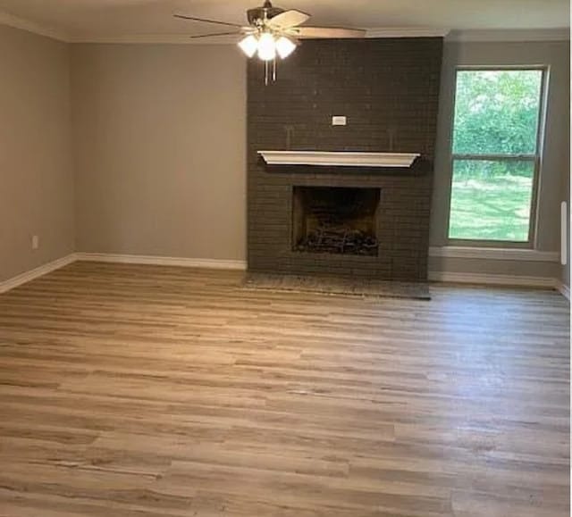 unfurnished living room featuring ceiling fan, crown molding, and wood finished floors