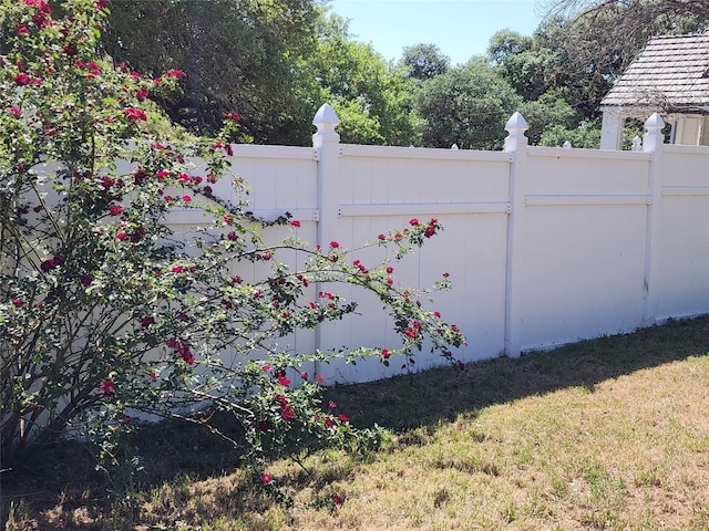 view of gate with a lawn and fence