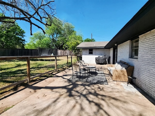 view of patio featuring a fenced backyard, an outdoor living space, and a trampoline