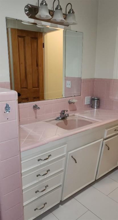 bathroom with tile patterned flooring and vanity