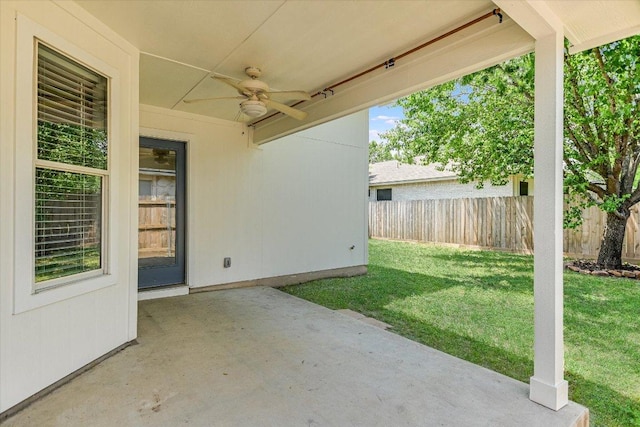 view of patio featuring a ceiling fan and fence