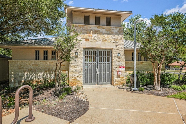 11518 James B Connolly Ln, Austin, TX 78748 - doorway to property with stone siding, stucco siding, a standing seam roof, and a metal roof