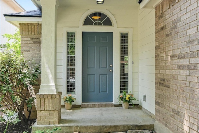 view of exterior entry with a porch