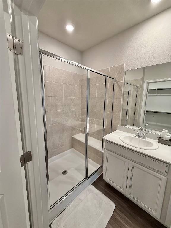 793 Lone Peak Way, Dripping Springs, TX 78620 - bathroom featuring a shower stall, wood finished floors, vanity, and recessed lighting