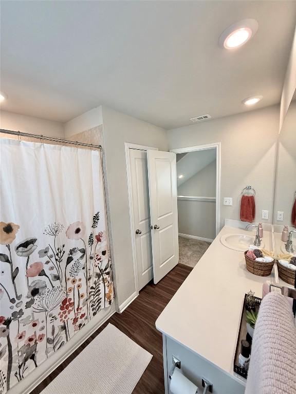 793 Lone Peak Way, Dripping Springs, TX 78620 - bathroom featuring vanity, wood finished floors, a shower with shower curtain, and recessed lighting
