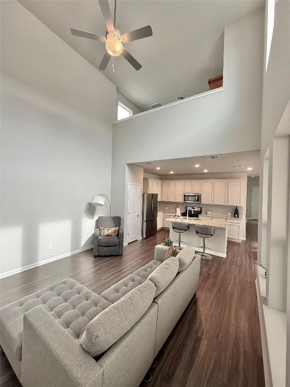 793 Lone Peak Way, Dripping Springs, TX 78620 - living room with a towering ceiling, ceiling fan, and dark wood-style flooring