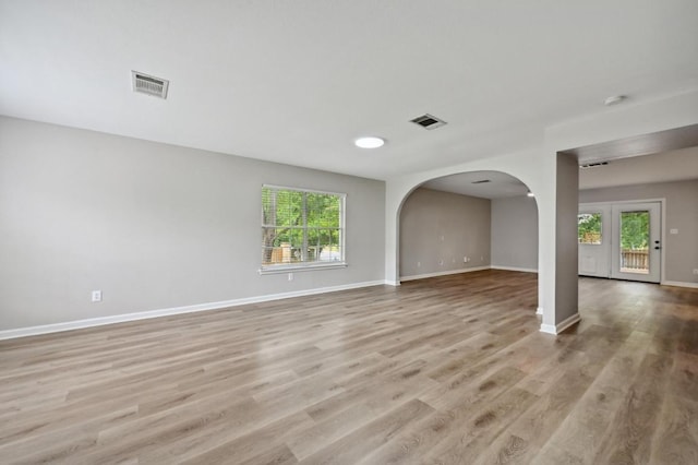 8139 Evadean Cir, Austin, TX 78745 - spare room with healthy amount of natural light, light wood-type flooring, baseboards, and arched walkways