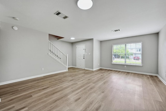 8139 Evadean Cir, Austin, TX 78745 - unfurnished living room with stairway, wood finished floors, and baseboards