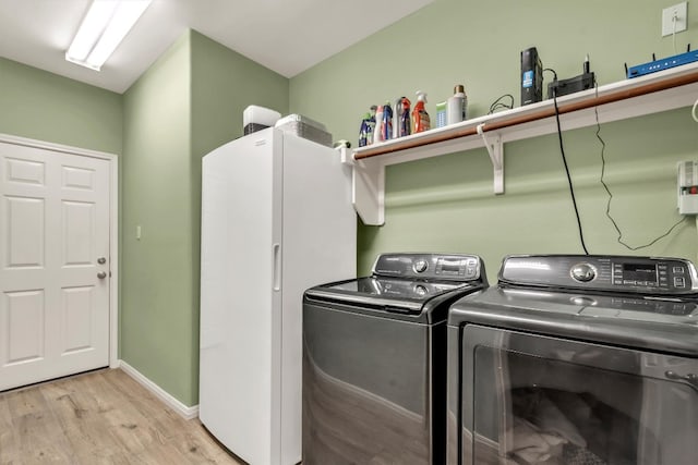 3820 Lagoona Dr, Round Rock, TX 78681 - laundry room featuring washing machine and dryer, light wood-style floors, and baseboards