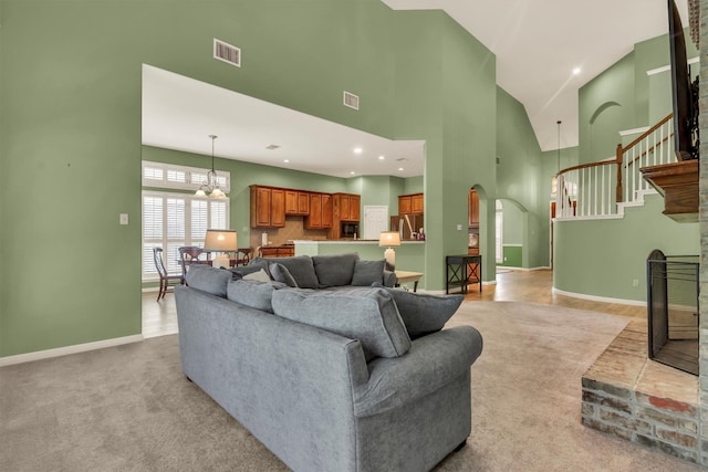 3820 Lagoona Dr, Round Rock, TX 78681 - living room featuring arched walkways, baseboards, high vaulted ceiling, a fireplace, and a chandelier