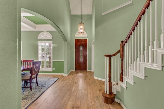 3820 Lagoona Dr, Round Rock, TX 78681 - foyer entrance featuring arched walkways, wood-type flooring, stairway, baseboards, and a high ceiling