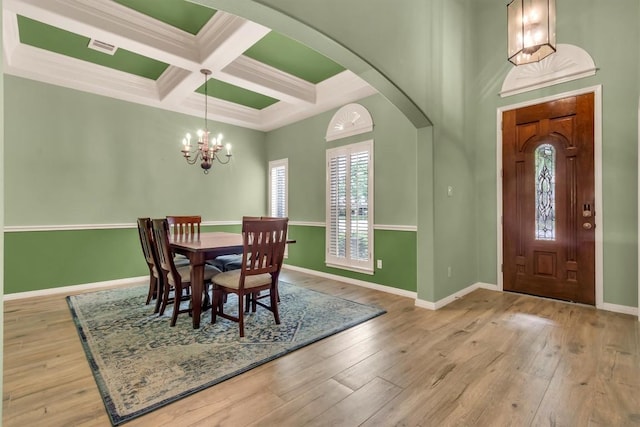 3820 Lagoona Dr, Round Rock, TX 78681 - dining area with coffered ceiling, arched walkways, a chandelier, hardwood / wood-style floors, and beam ceiling