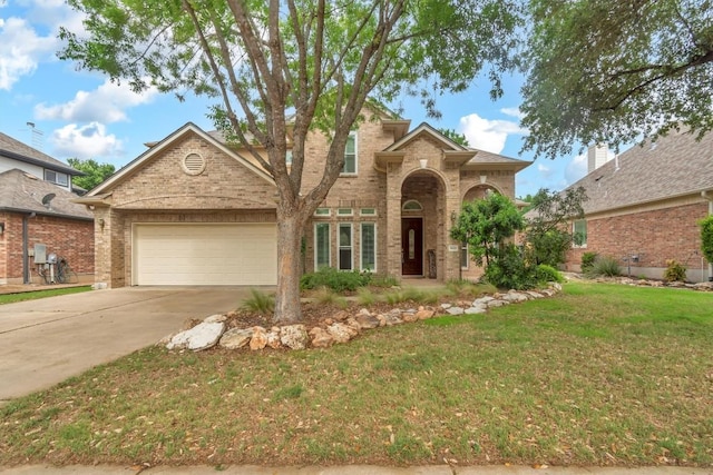 3820 Lagoona Dr, Round Rock, TX 78681 - traditional-style house featuring a garage, concrete driveway, a front yard, and brick siding
