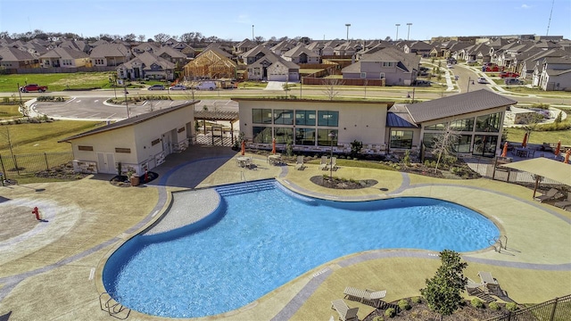 view of swimming pool with fence, a patio, a residential view, and a fenced in pool