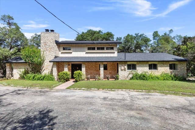 502 Grace Ln, Austin, TX 78746 - view of front facade featuring a front lawn and a chimney