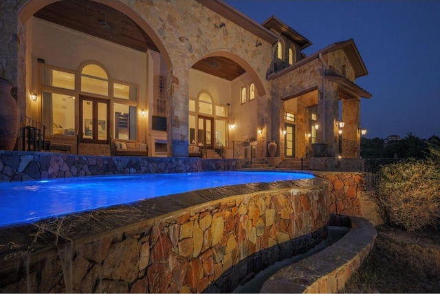 8315 Lime Creek Rd, Volente, TX 78641 - pool at night featuring french doors and an outdoor pool