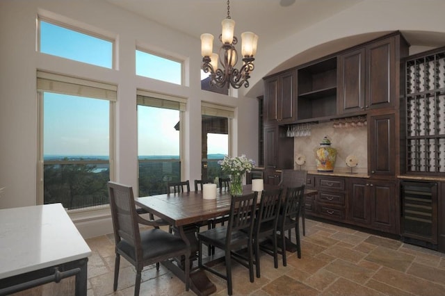 8315 Lime Creek Rd, Volente, TX 78641 - dining area featuring a chandelier, healthy amount of natural light, and stone tile floors