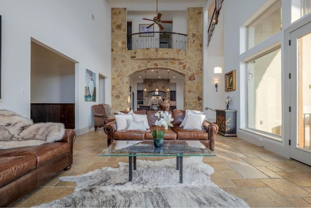 8315 Lime Creek Rd, Volente, TX 78641 - living room featuring stone tile floors, a high ceiling, and a ceiling fan