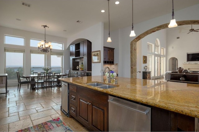 8315 Lime Creek Rd, Volente, TX 78641 - kitchen with a sink, stainless steel dishwasher, arched walkways, a high ceiling, and open floor plan