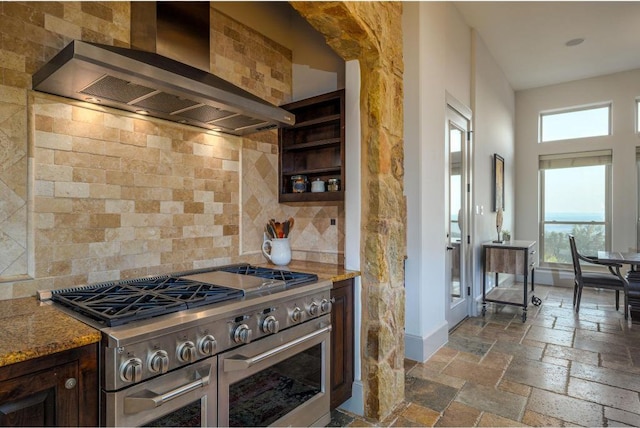 8315 Lime Creek Rd, Volente, TX 78641 - kitchen featuring double oven range, wall chimney range hood, healthy amount of natural light, and tasteful backsplash