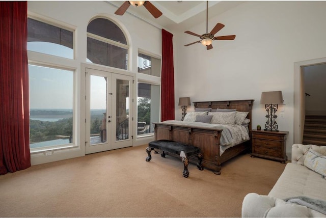 8315 Lime Creek Rd, Volente, TX 78641 - carpeted bedroom with access to exterior, a high ceiling, multiple windows, french doors, and ceiling fan