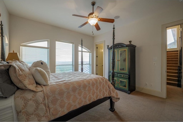 8315 Lime Creek Rd, Volente, TX 78641 - bedroom with multiple windows, light colored carpet, baseboards, and a ceiling fan