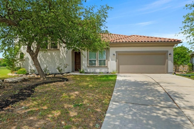 mediterranean / spanish-style home with stucco siding, an attached garage, a tile roof, driveway, and a front yard