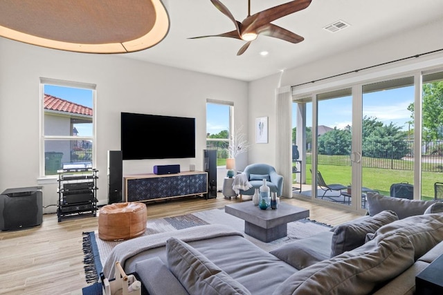 living room featuring recessed lighting, light wood-style flooring, visible vents, and ceiling fan