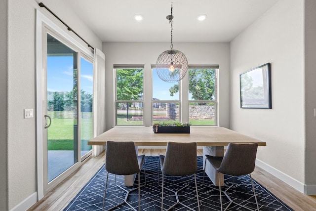 dining space with recessed lighting, wood finished floors, and baseboards