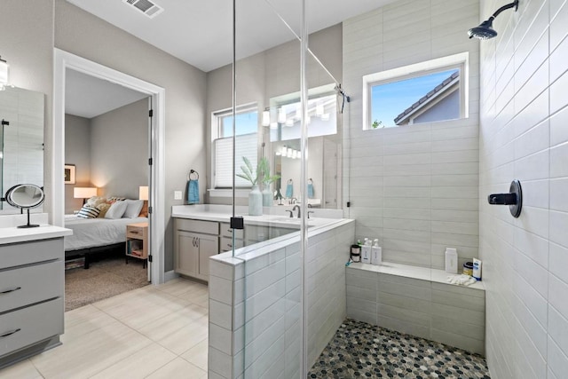 full bath with visible vents, connected bathroom, a healthy amount of sunlight, and a stall shower