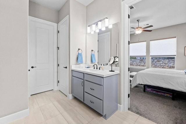 ensuite bathroom with tile patterned floors, ensuite bathroom, baseboards, ceiling fan, and vanity