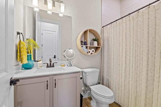 bathroom featuring toilet, a shower with curtain, and vanity