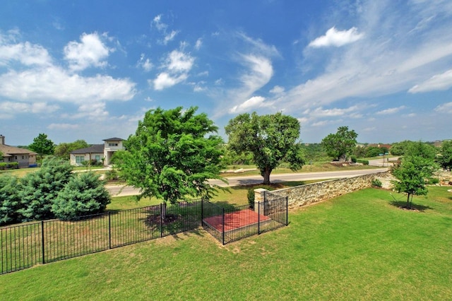 view of home's community featuring fence and a lawn