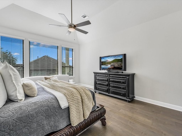 bedroom with wood finished floors, visible vents, baseboards, and multiple windows